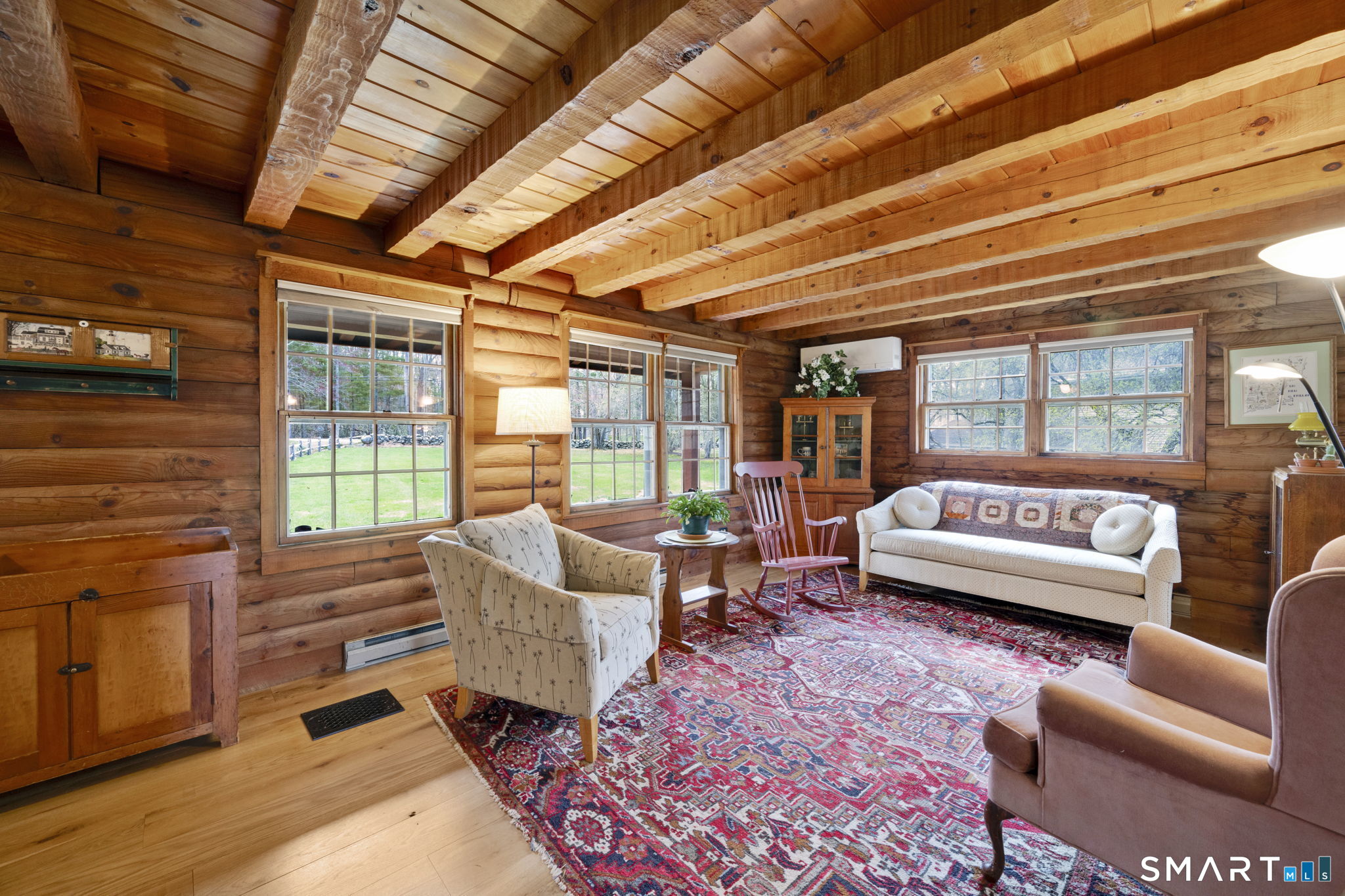 260 West Street Hebron, CT 06248 - Photo 6 of 40 a living room with furniture and a floor to ceiling window next to a potted plant