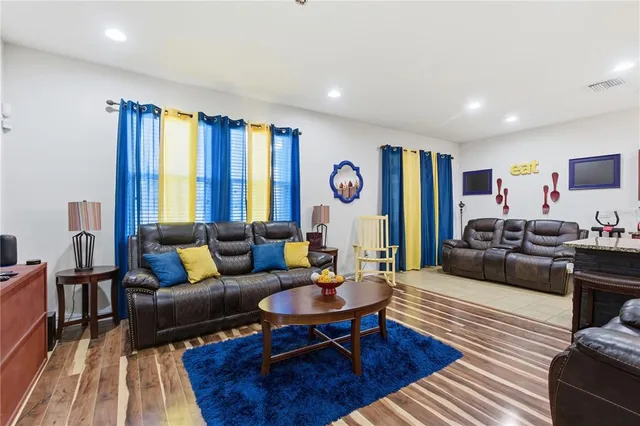 a living room with furniture kitchen and a couch