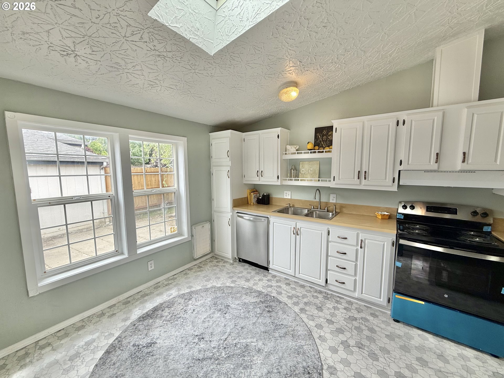 1282 3rd Street, Unit 37 Lafayette, OR 97127 - Photo 7 of 28 a kitchen with granite countertop a stove a sink dishwasher and a refrigerator
