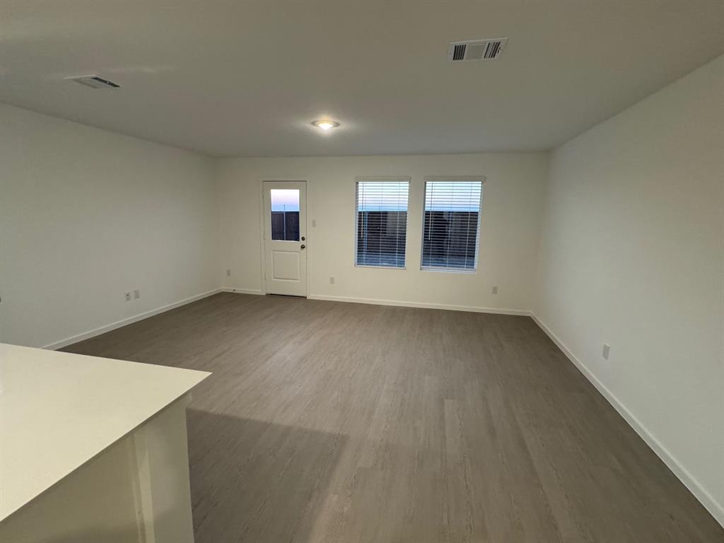 7809 Bent Gale Road Pilot Point, TX 76258 - Photo 16 of 17 an empty room with wooden floor and windows