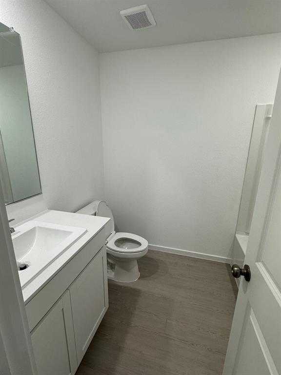 7809 Bent Gale Road Pilot Point, TX 76258 - Photo 7 of 17 a white toilet sitting next to a white sink and vanity
