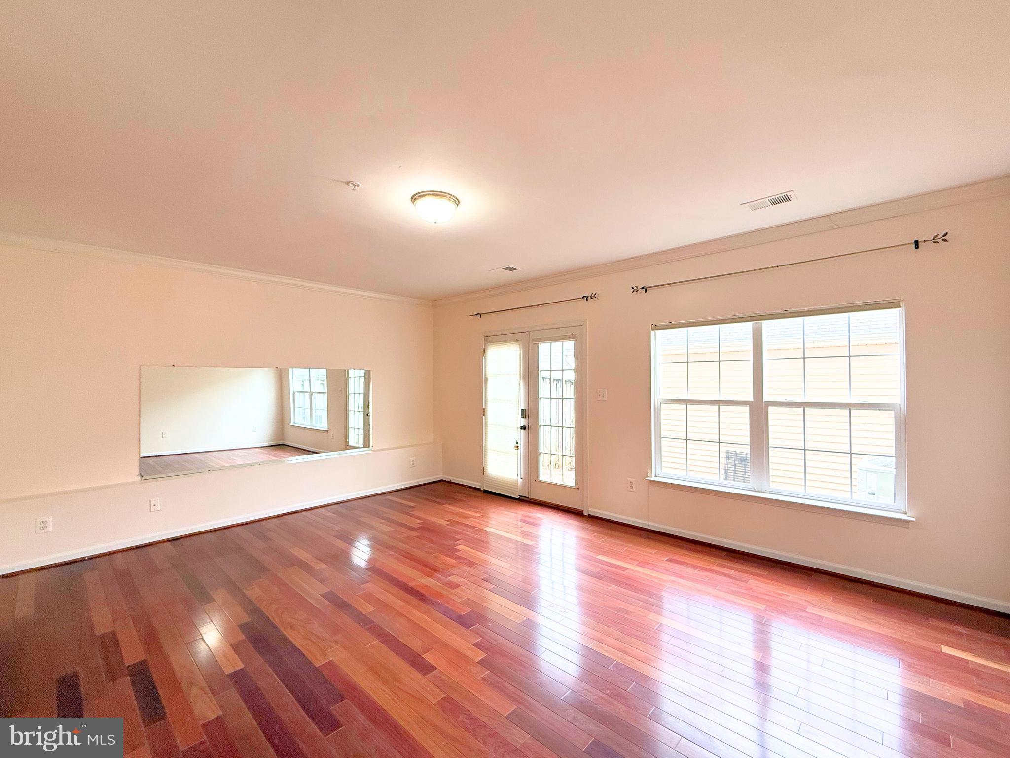 13429 Rising Sun Lane Germantown, MD 20874 - Photo 19 of 27 an empty room with wooden floor and windows