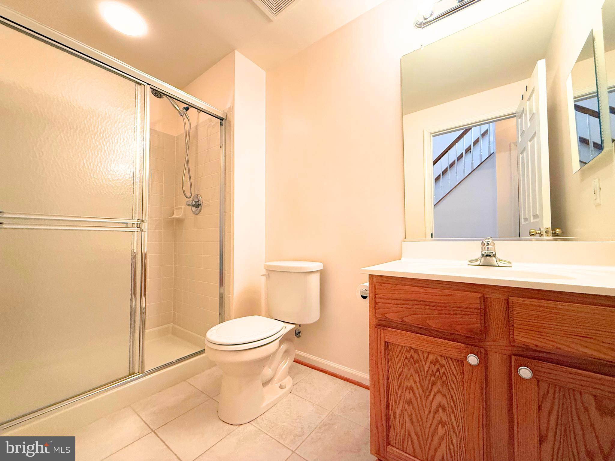 13429 Rising Sun Lane Germantown, MD 20874 - Photo 25 of 27 a bathroom with a granite countertop sink toilet and shower