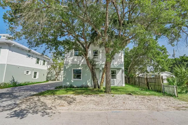 a large tree in front of a house