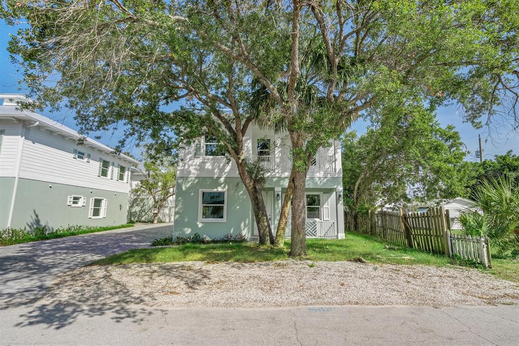 667 Southwest Cleveland Avenue, Unit 2 Stuart, FL 34994 - Photo 2 of 10 a large tree in front of a house