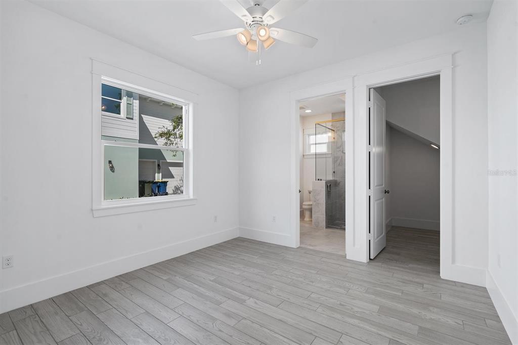 667 Southwest Cleveland Avenue, Unit 2 Stuart, FL 34994 - Photo 8 of 10 wooden floor in an empty room with a window