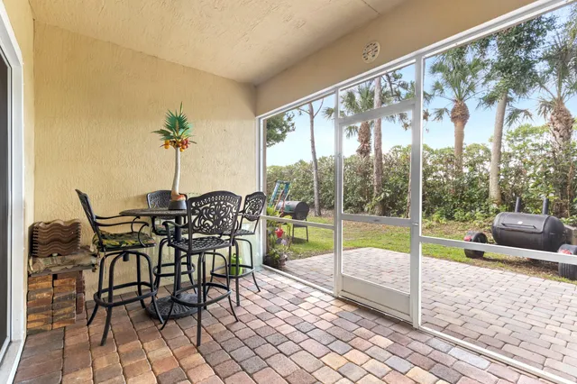 a dining room with furniture and floor to ceiling window