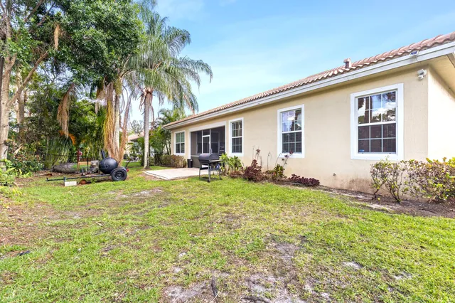 a backyard of a house with table and chairs