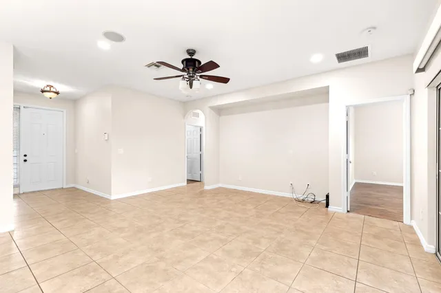a view of room with a ceiling fan and carpet