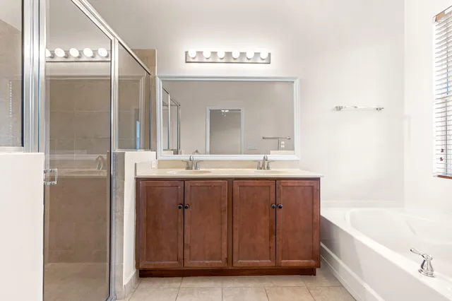 a bathroom with a bathtub a sink and a mirror