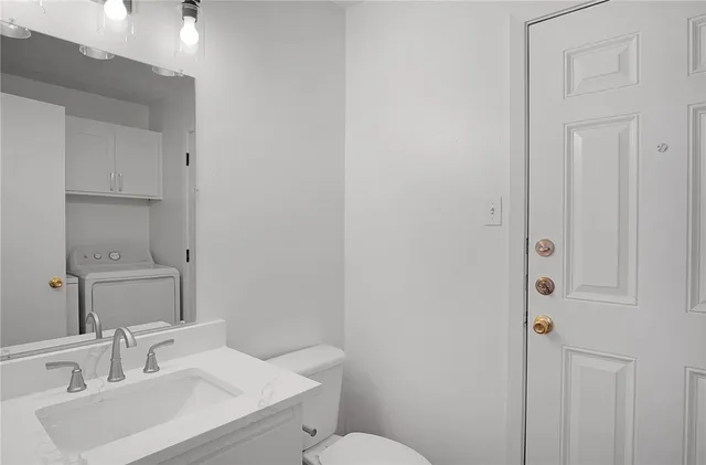 a bathroom with a sink toilet and vanity