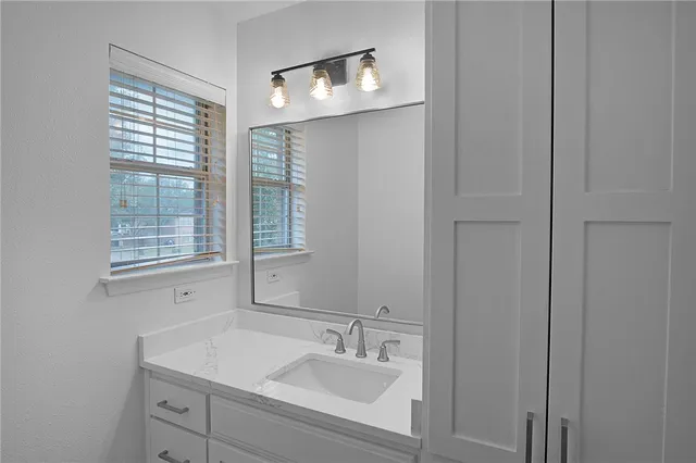 a bathroom with a sink and a mirror