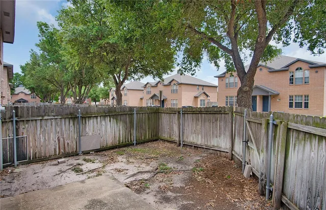 a backyard of a house with wooden fence