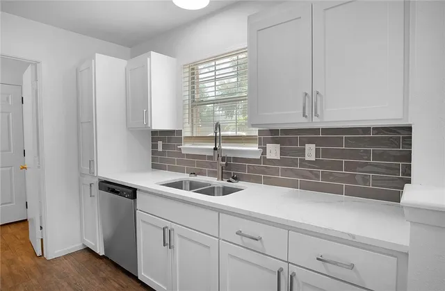 a kitchen with appliances cabinets and a sink