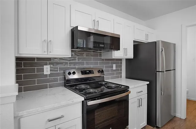 a kitchen with stainless steel appliances and cabinets