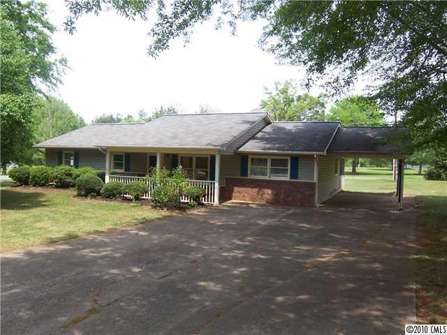 409 Robinson Creek Road Bostic, NC 28018 - Photo 1 of 9 a front view of a house with garden