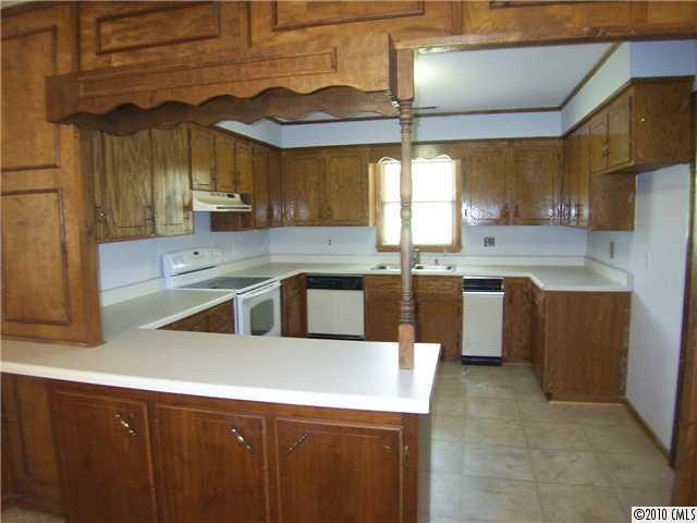 409 Robinson Creek Road Bostic, NC 28018 - Photo 4 of 9 a kitchen with stainless steel appliances granite countertop a sink a stove and a refrigerator