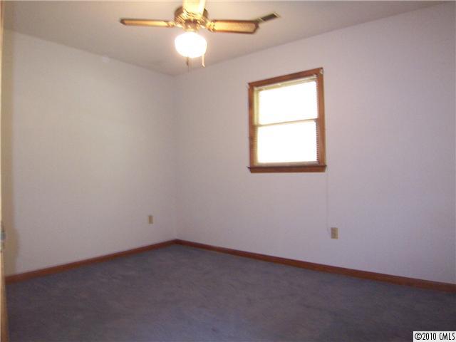 409 Robinson Creek Road Bostic, NC 28018 - Photo 7 of 9 an empty room with a window and a fan