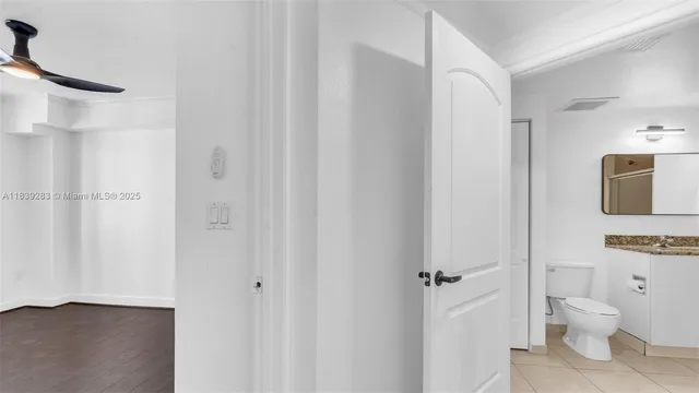 a view of an empty room with a ceiling fan