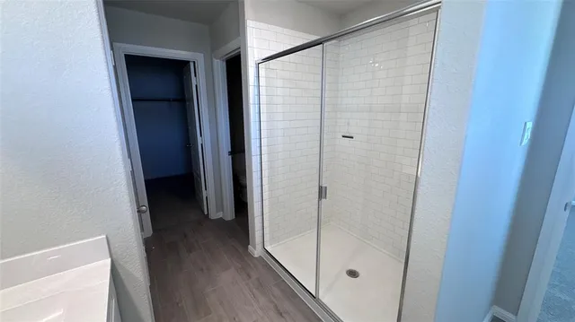 a bathroom with a glass shower door