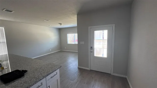 wooden floor in an empty room with a window
