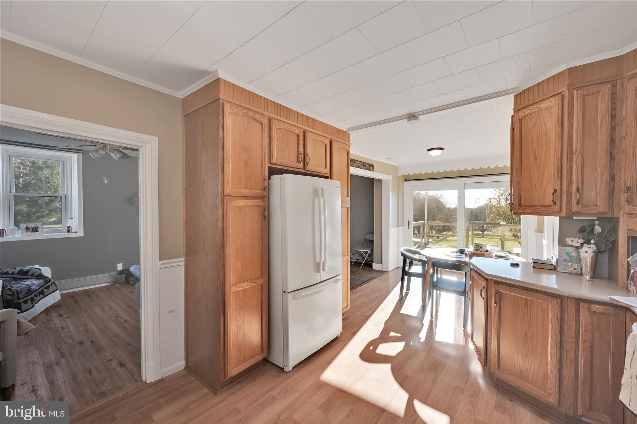 116 Mill Road Bernville, PA 19506 - Photo 11 of 62 a kitchen with stainless steel appliances granite countertop a refrigerator a stove a sink dishwasher and white cabinets with wooden floor