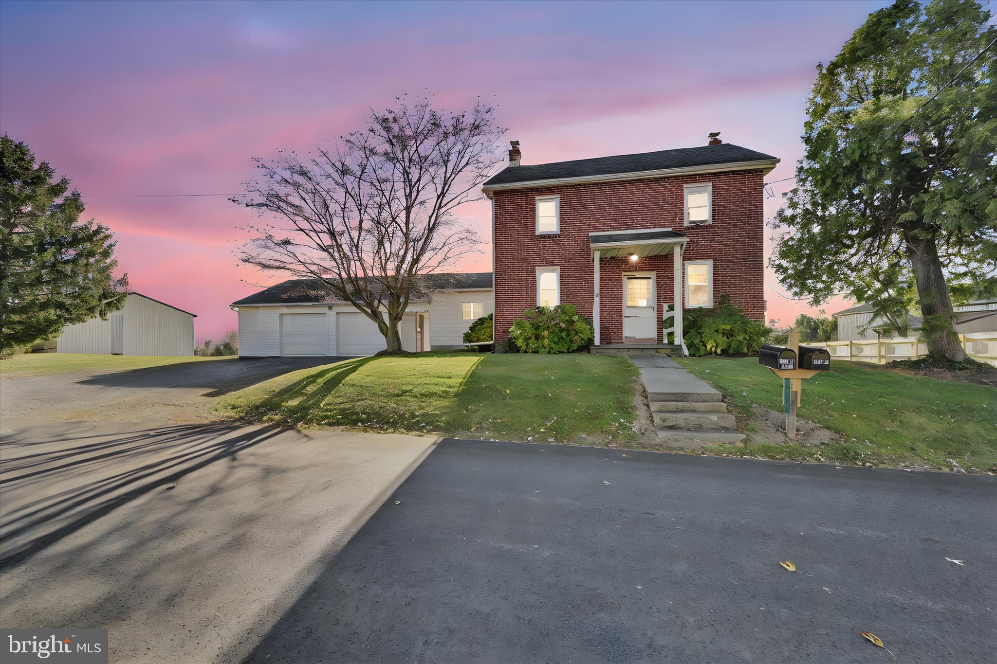116 Mill Road Bernville, PA 19506 - Photo 3 of 62 a view of a brick house next to a yard with big trees