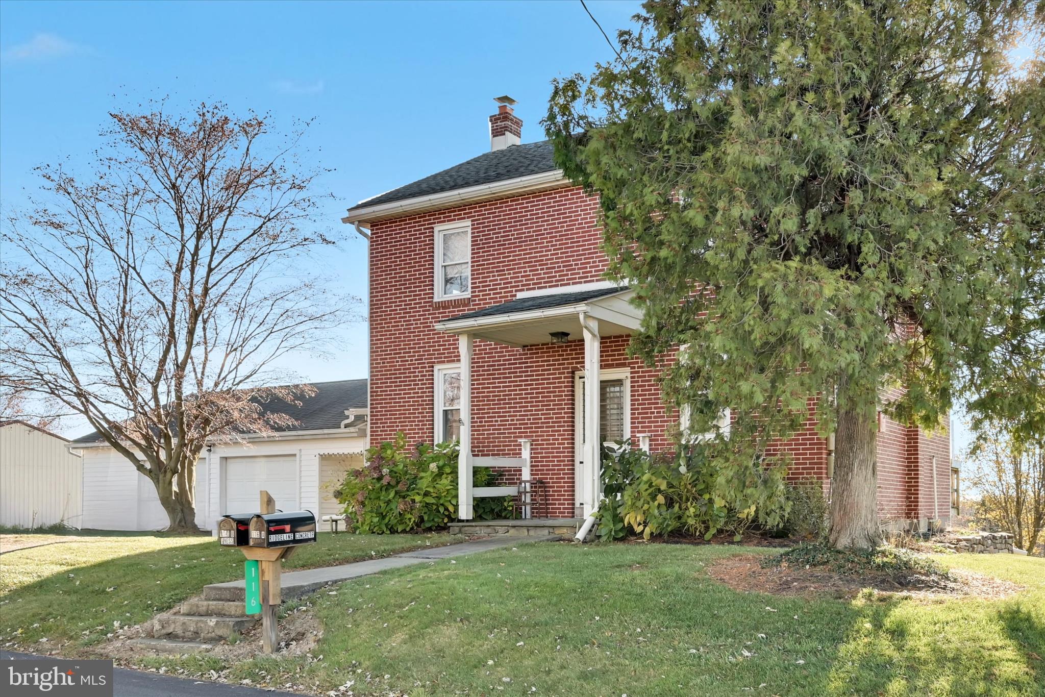 116 Mill Road Bernville, PA 19506 - Photo 7 of 62 a brick house with a large tree in front of it