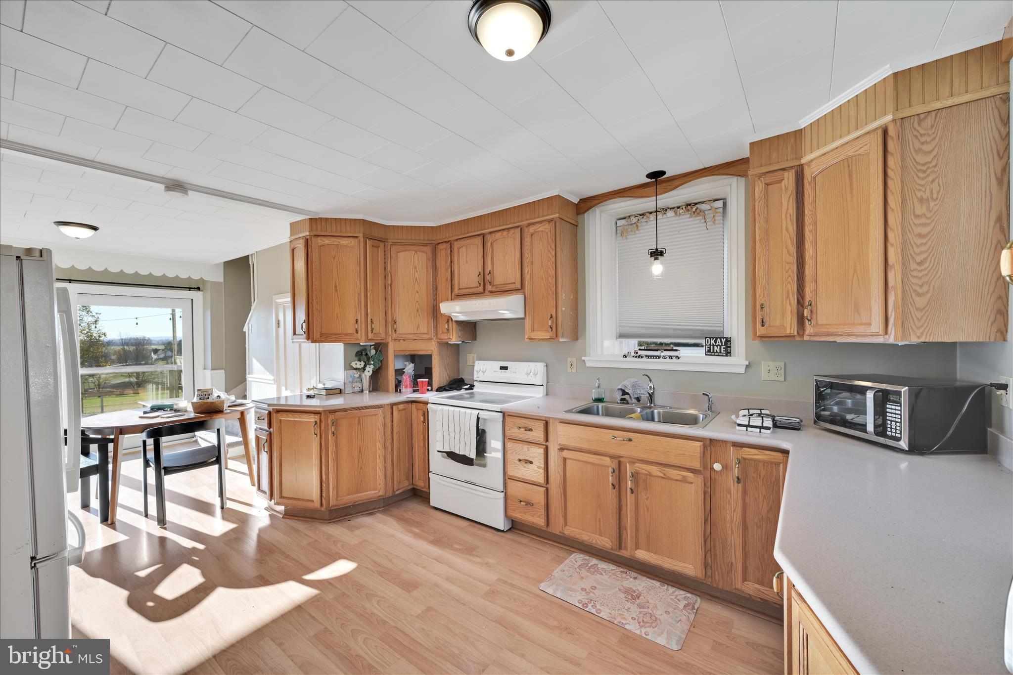 116 Mill Road Bernville, PA 19506 - Photo 10 of 62 a kitchen with stainless steel appliances granite countertop a stove a sink dishwasher and cabinets with wooden floor