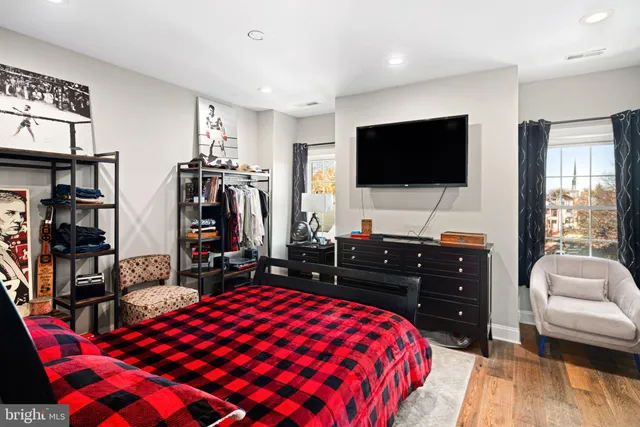 a bedroom with a bed and a flat screen tv