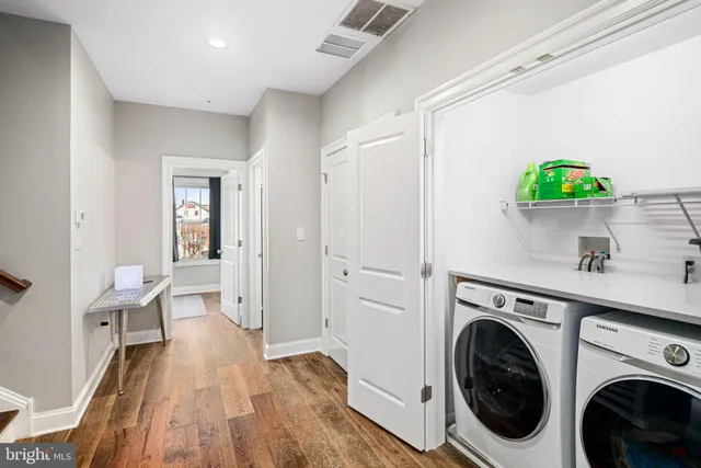 a view of entryway with workspace and wooden floor