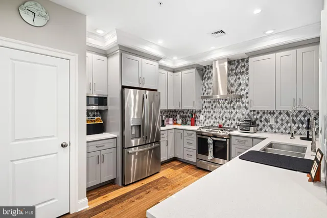 a kitchen with a sink appliances and cabinets