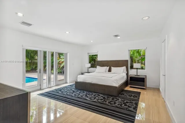 a bedroom with a large bed and a window