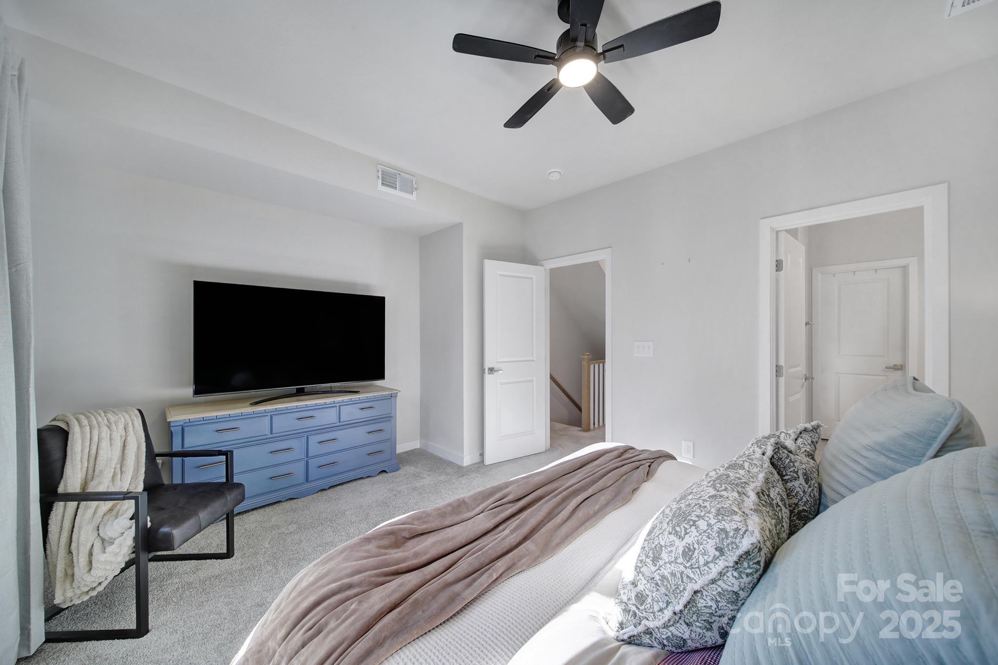 6120 Sta Xing Avenue Charlotte, NC 28217 - Photo 14 of 31 a bedroom with a bed and a flat screen tv