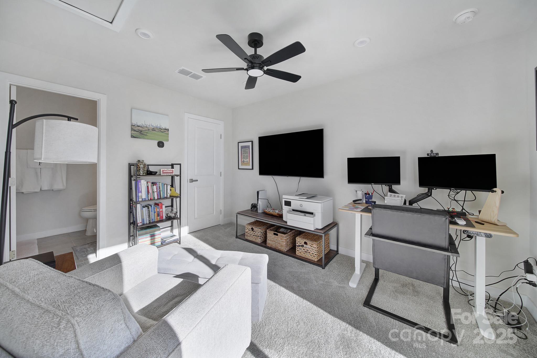 6120 Sta Xing Avenue Charlotte, NC 28217 - Photo 20 of 31 a living room with furniture and a flat screen tv