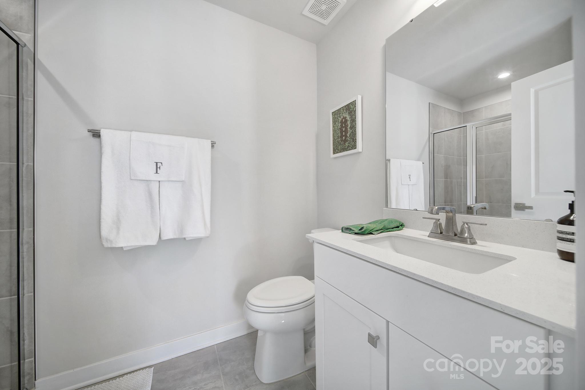 6120 Sta Xing Avenue Charlotte, NC 28217 - Photo 22 of 31 a bathroom with a toilet sink and mirror