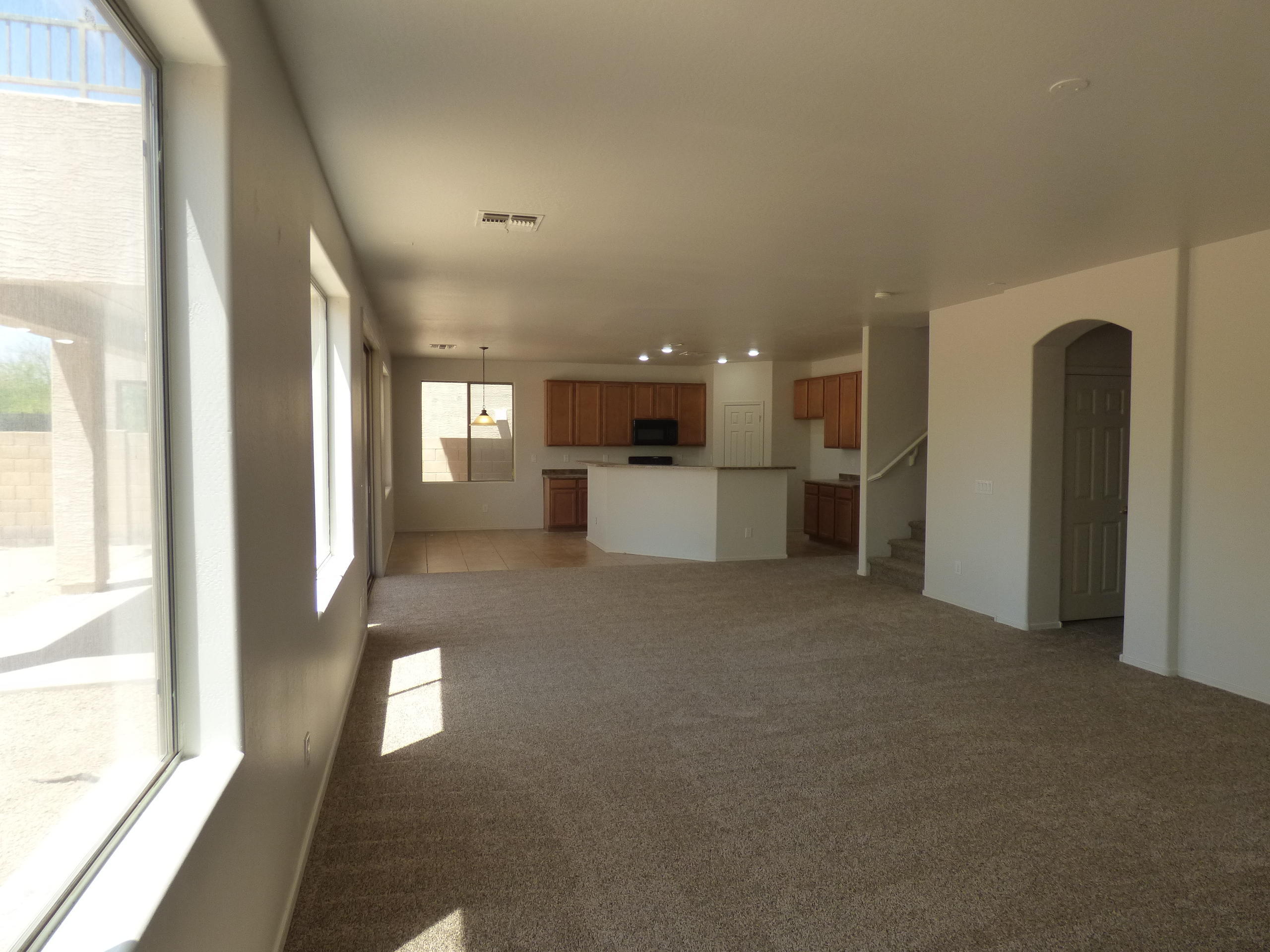 5617 West Carson Road Laveen, AZ 85339 - Photo 17 of 56 a view of a big room with windows and chandelier