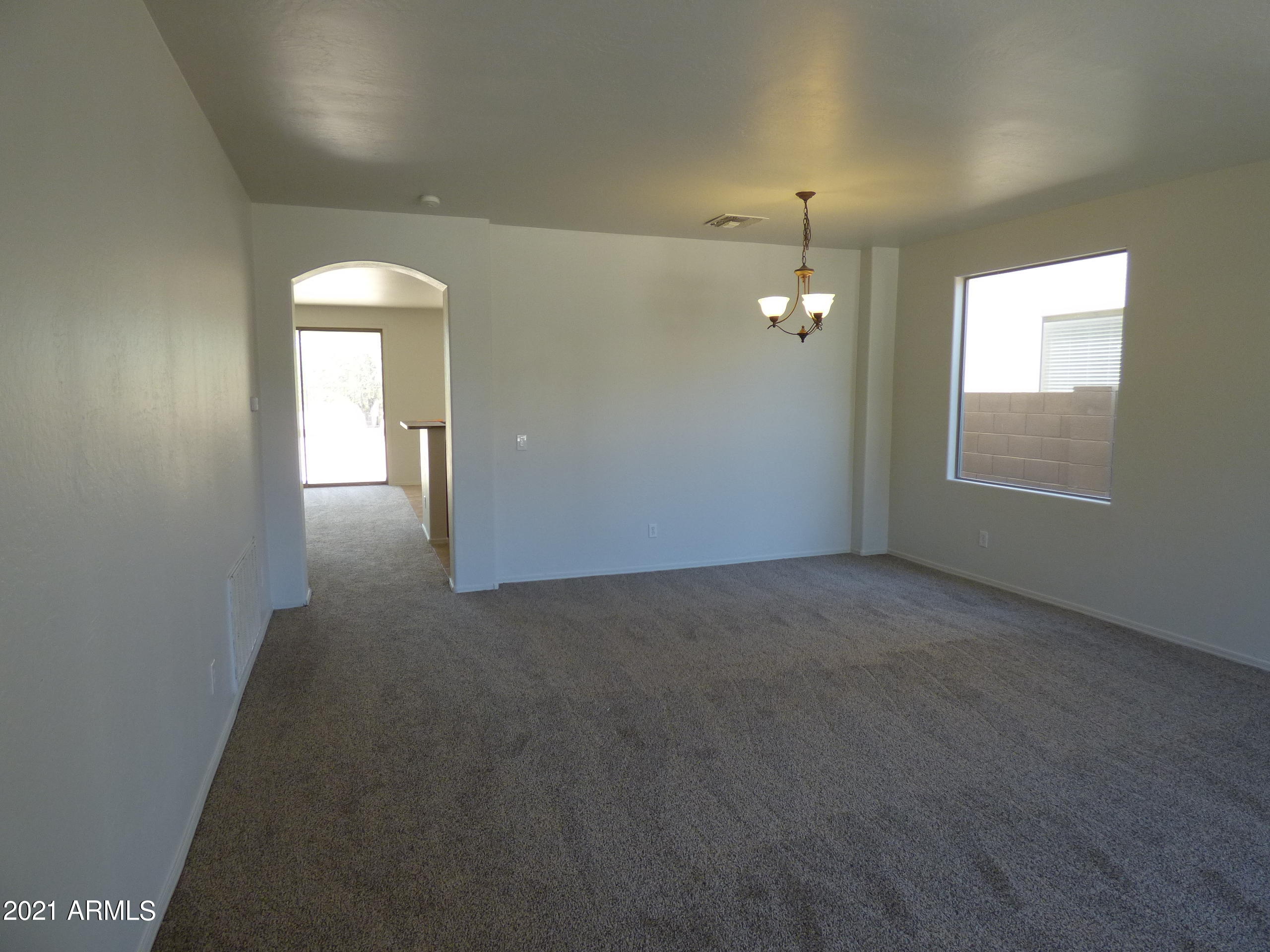 5617 West Carson Road Laveen, AZ 85339 - Photo 2 of 56 an empty room with windows and fireplace