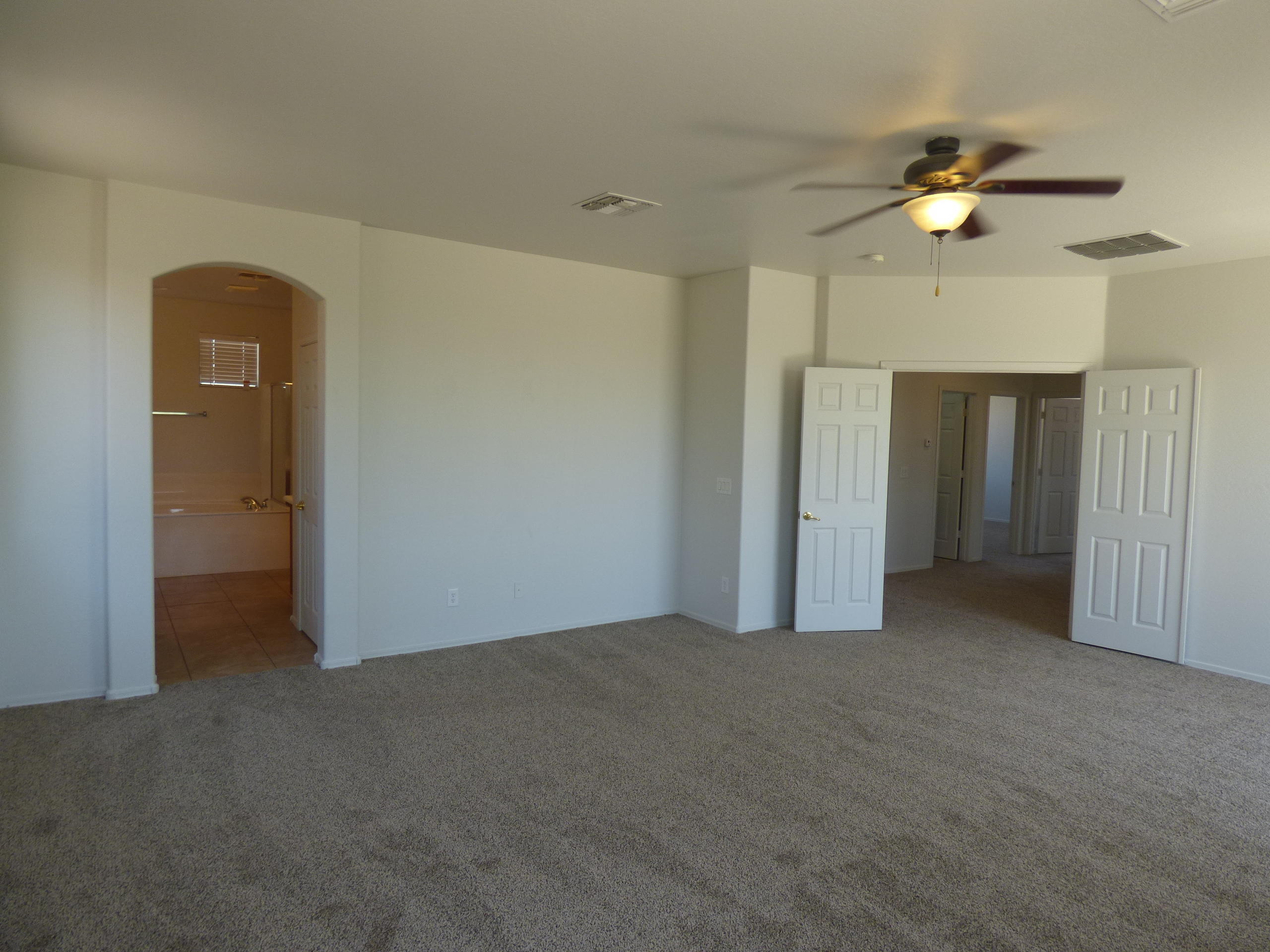 5617 West Carson Road Laveen, AZ 85339 - Photo 25 of 56 a view of empty room with a ceiling fan