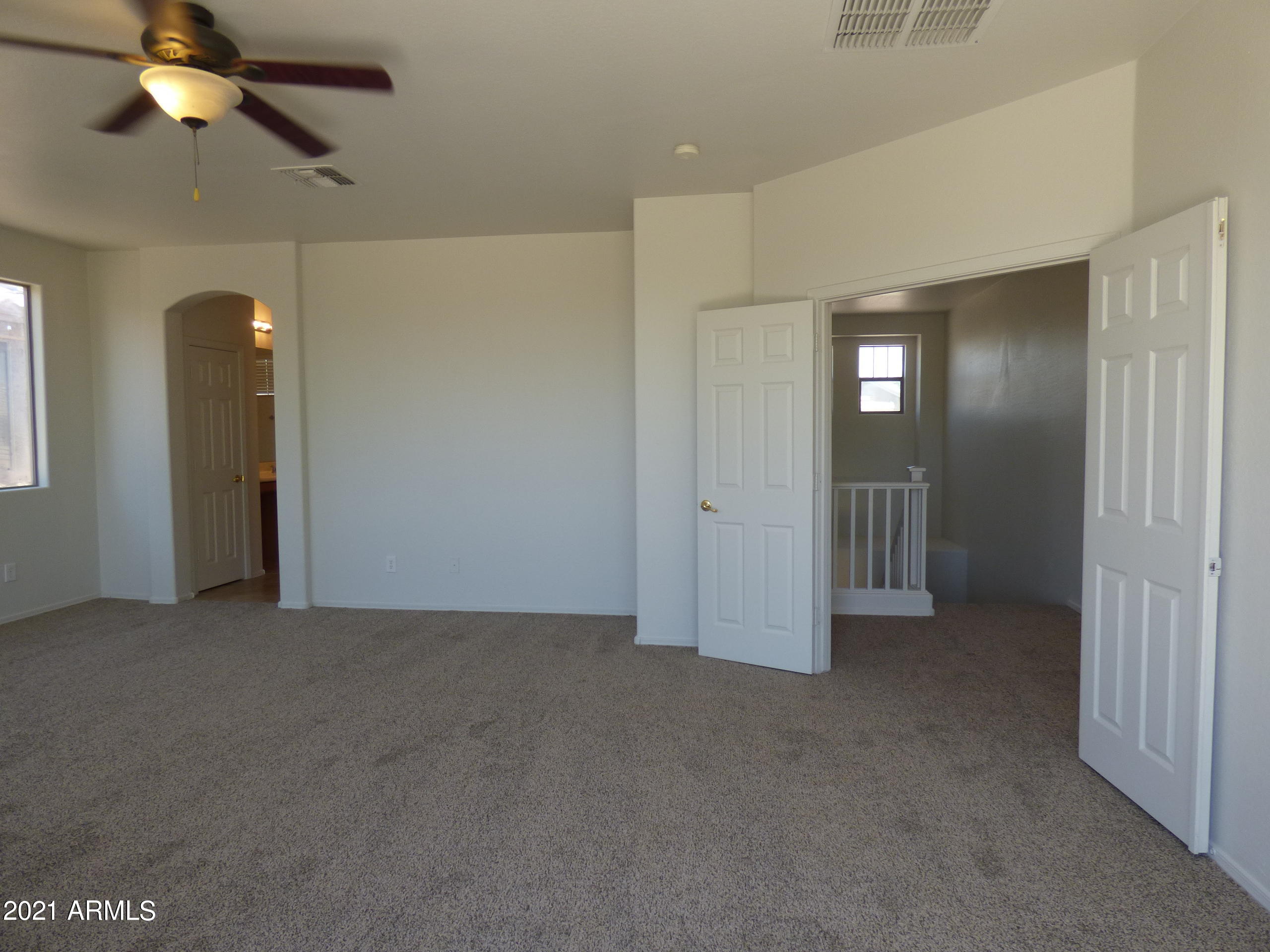 5617 West Carson Road Laveen, AZ 85339 - Photo 34 of 56 an empty room with closet and windows