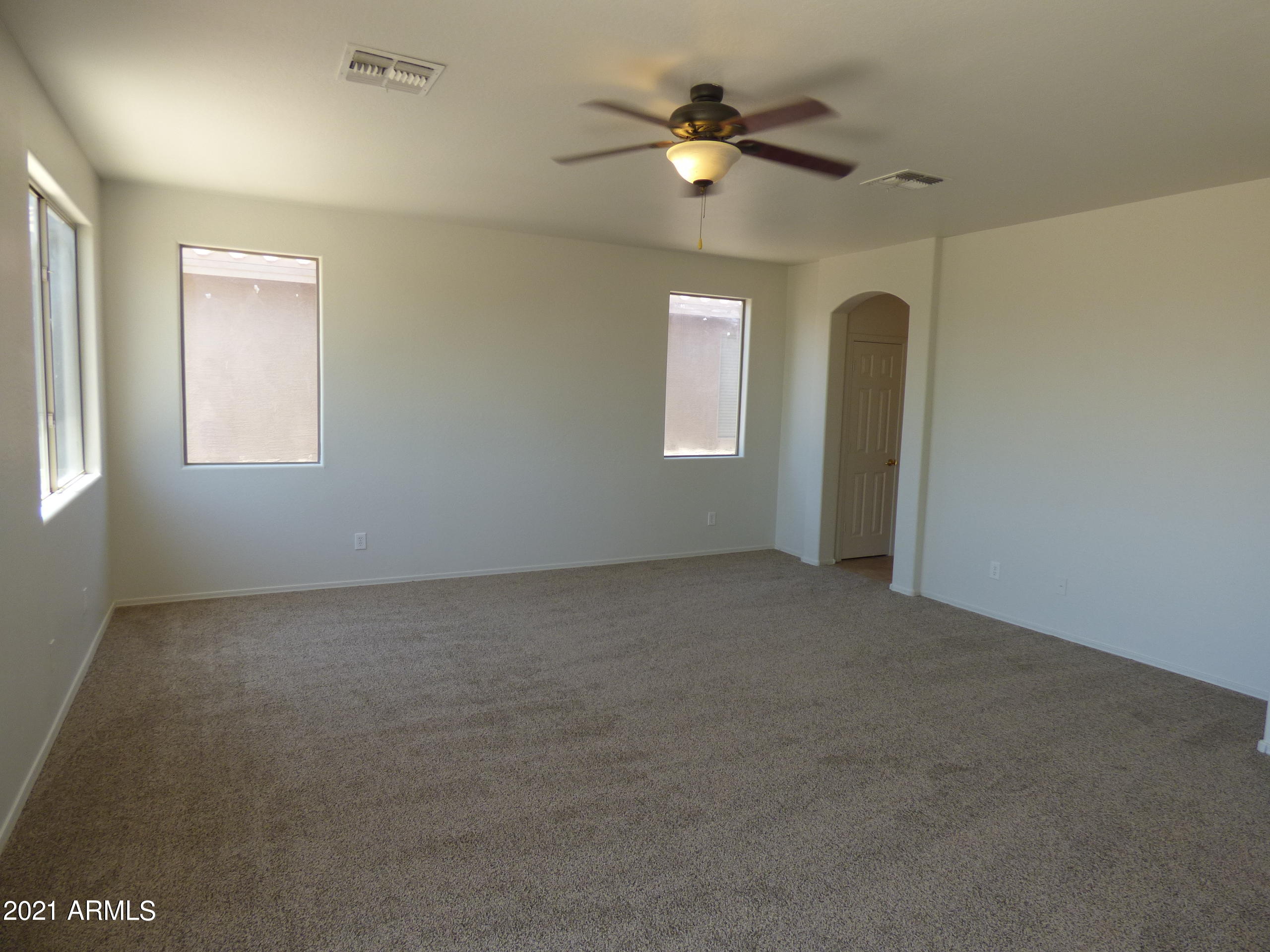 5617 West Carson Road Laveen, AZ 85339 - Photo 35 of 56 an empty room with windows and fan