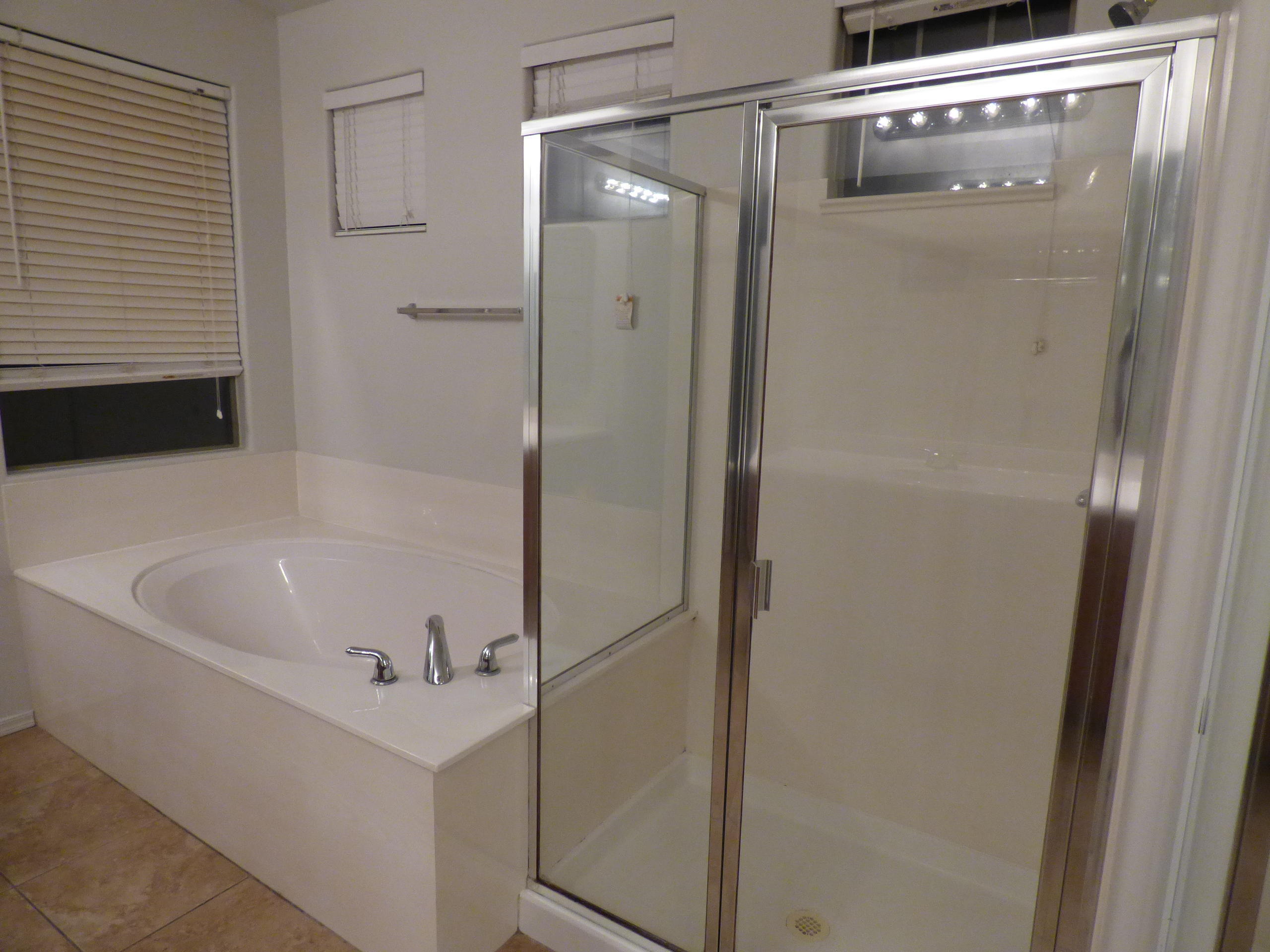 5617 West Carson Road Laveen, AZ 85339 - Photo 38 of 56 a bathroom with a tub and a shower