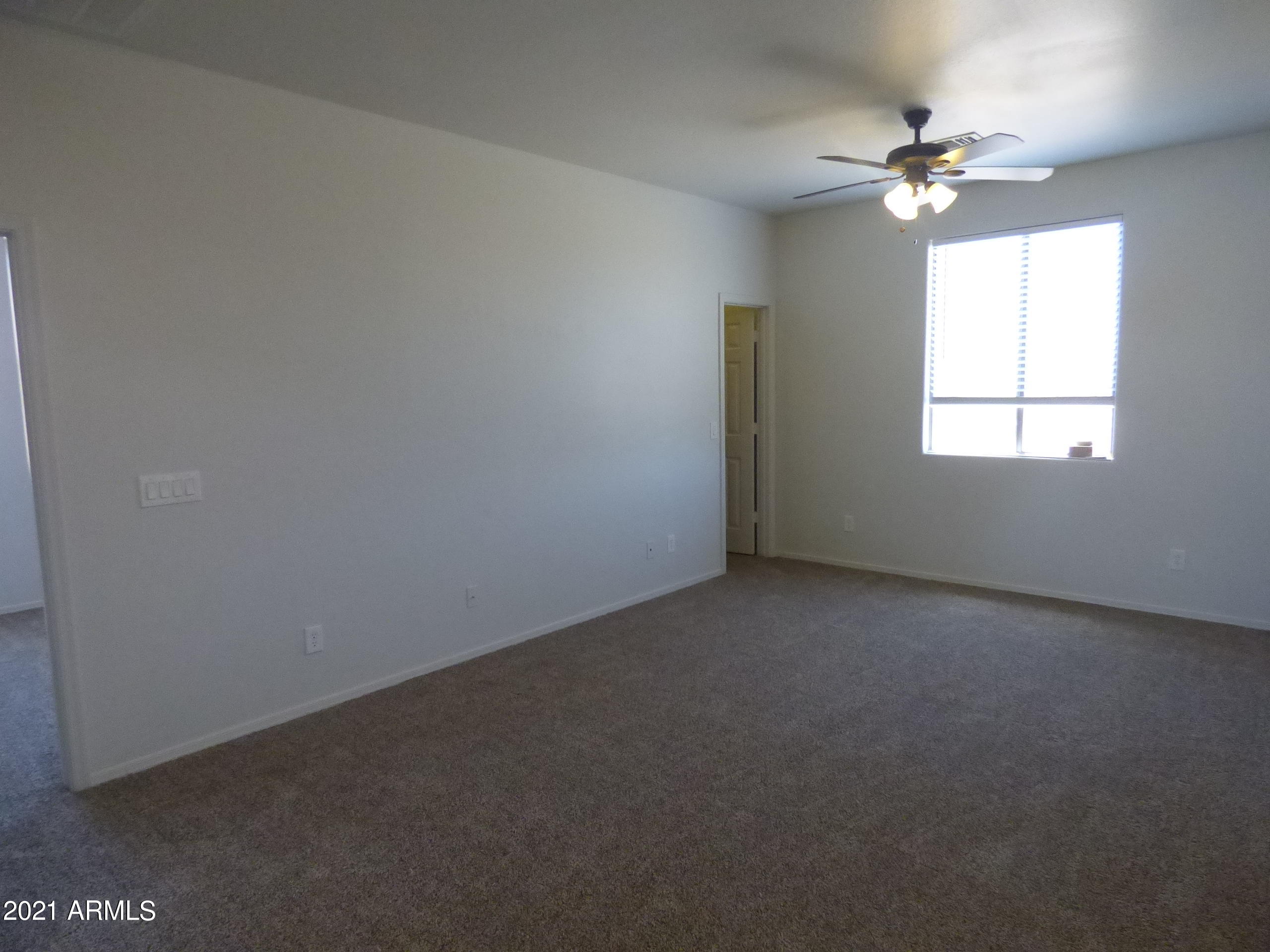 5617 West Carson Road Laveen, AZ 85339 - Photo 42 of 56 an empty room with windows and fan