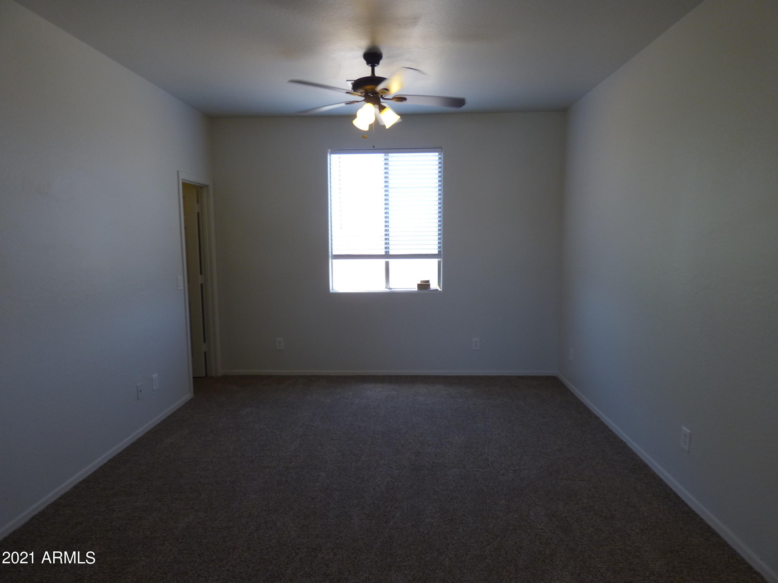 5617 West Carson Road Laveen, AZ 85339 - Photo 43 of 56 an empty room with a window and a fan
