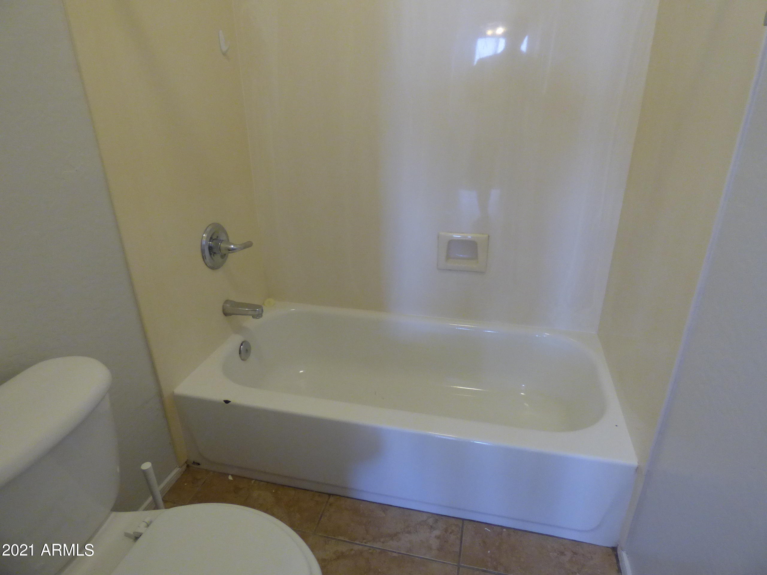 5617 West Carson Road Laveen, AZ 85339 - Photo 47 of 56 a bath tub sitting next to a white toilet