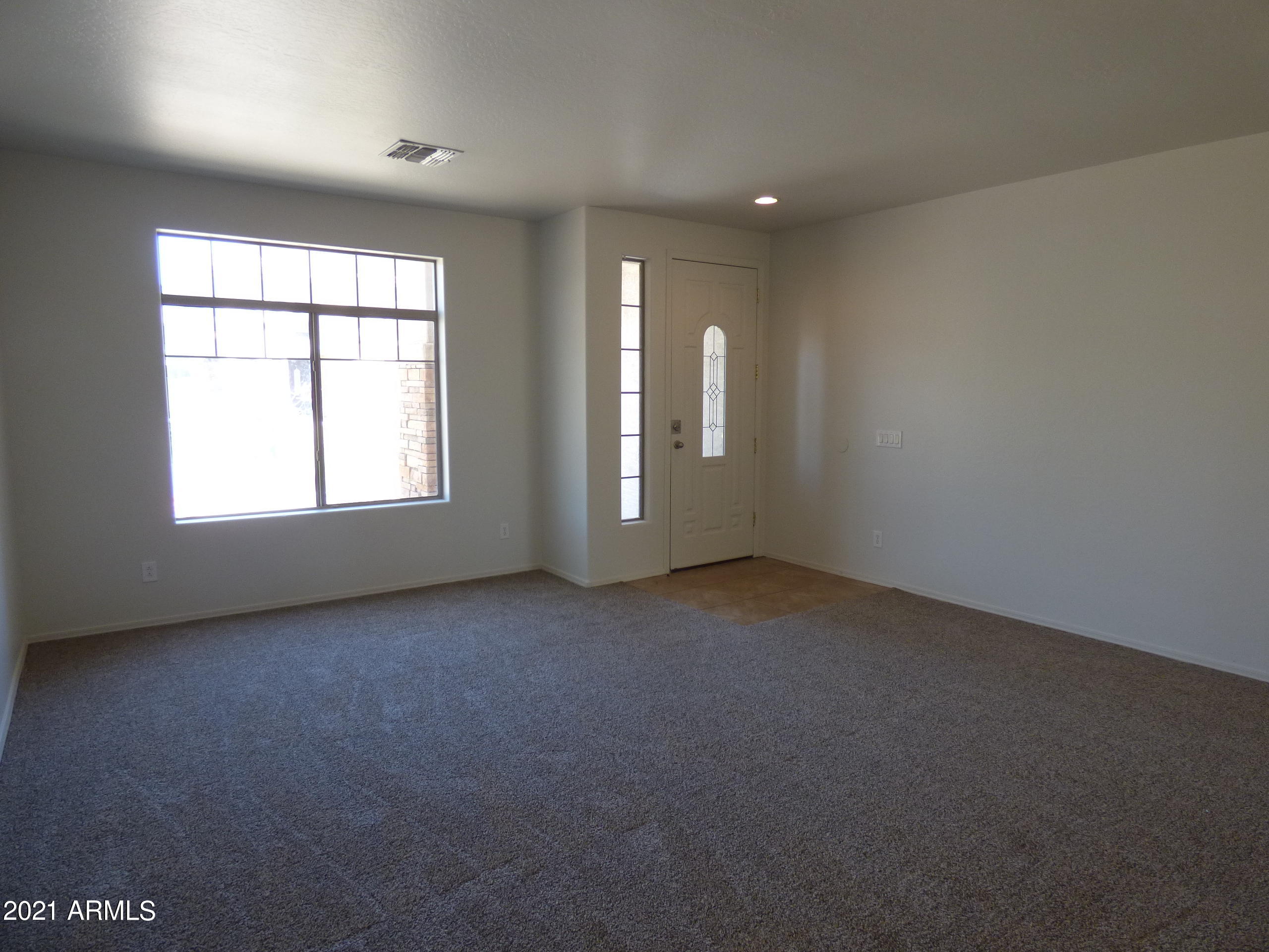 5617 West Carson Road Laveen, AZ 85339 - Photo 5 of 56 an empty room with windows