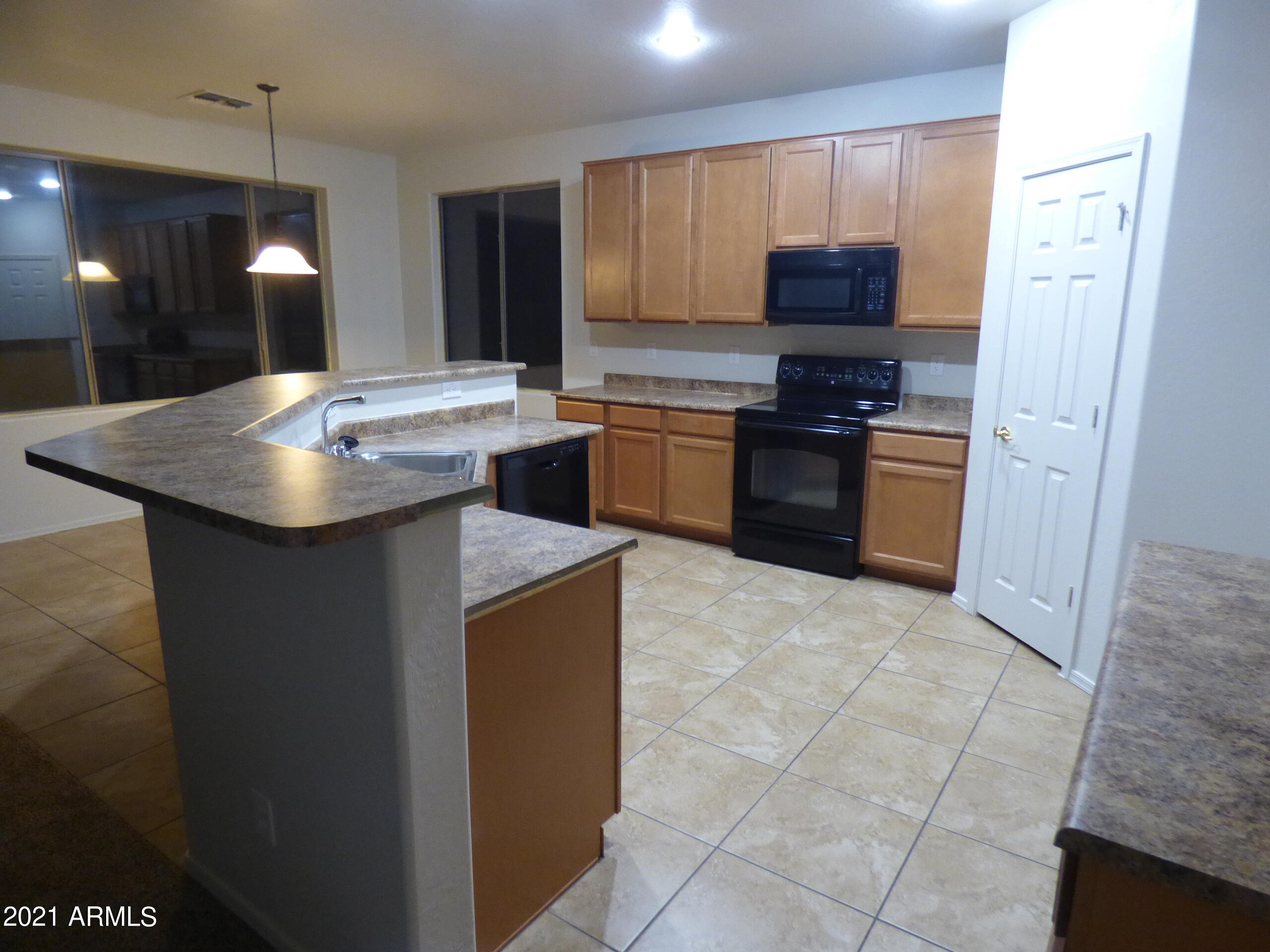 5617 West Carson Road Laveen, AZ 85339 - Photo 7 of 56 a kitchen with a sink a stove a refrigerator and a oven
