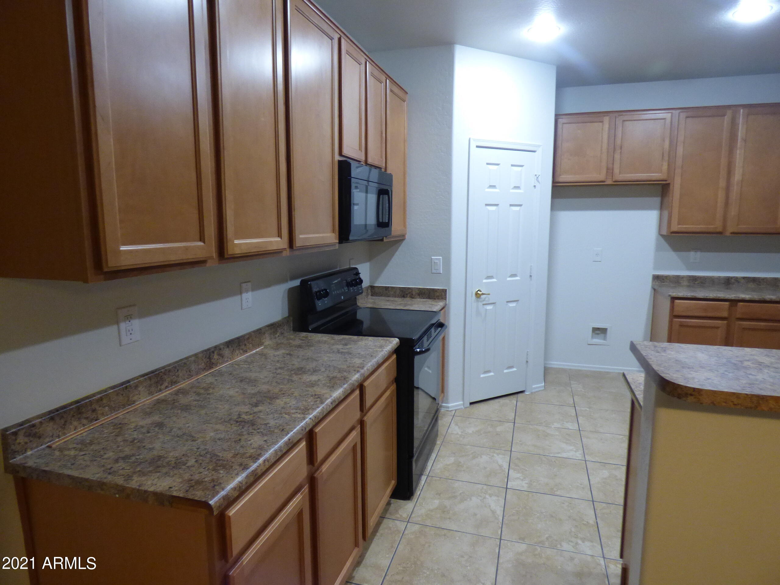 5617 West Carson Road Laveen, AZ 85339 - Photo 8 of 56 a kitchen with stainless steel appliances granite countertop a sink and a stove