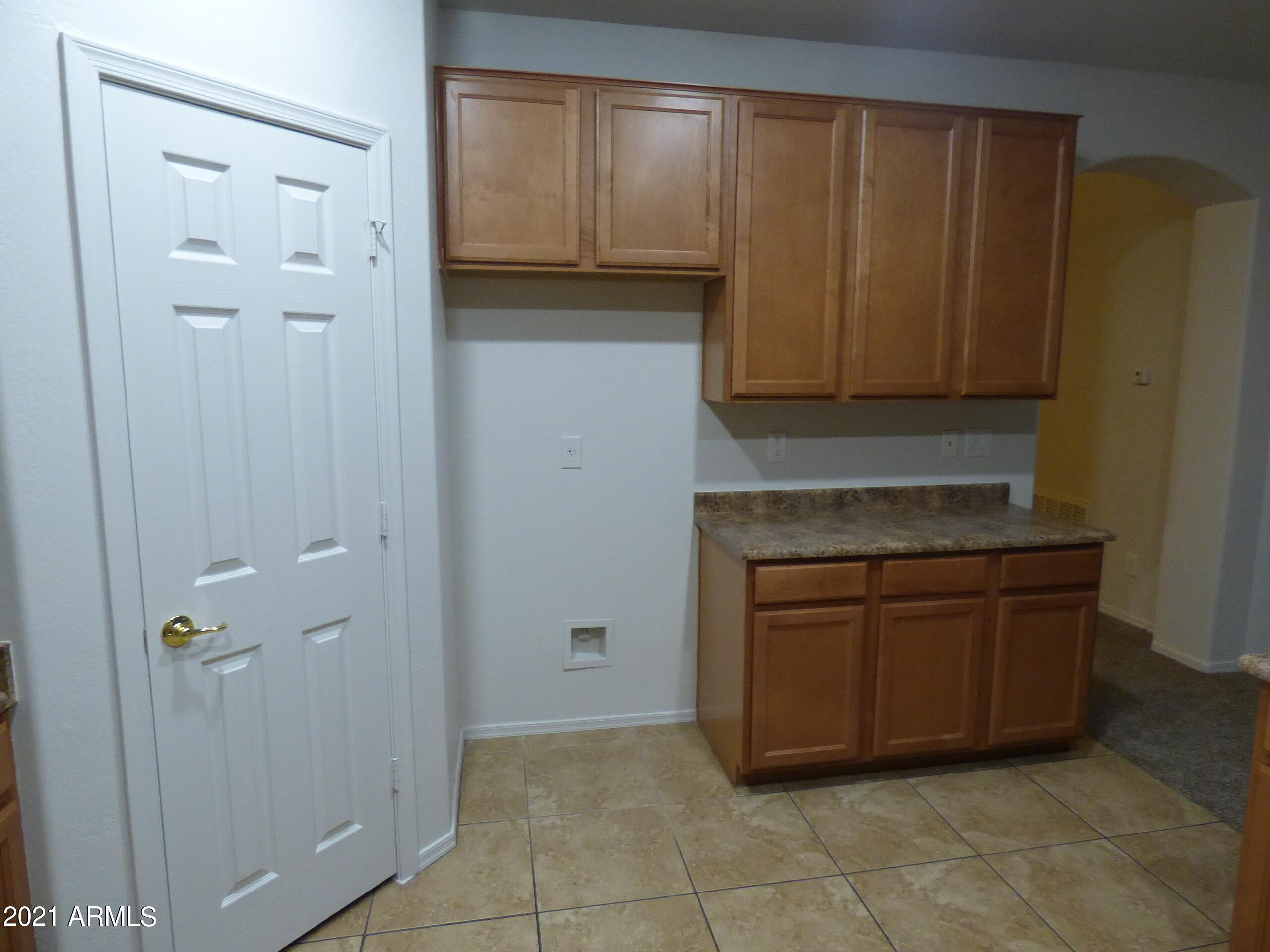 5617 West Carson Road Laveen, AZ 85339 - Photo 9 of 56 a kitchen with granite countertop cabinets and window