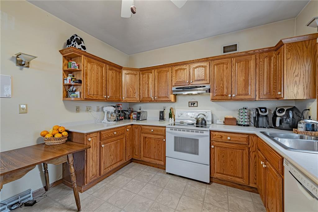 121 Hamilton Avenue Vandergrift, PA 15690 - Photo 11 of 25 a kitchen with stainless steel appliances granite countertop a sink dishwasher stove and cabinets